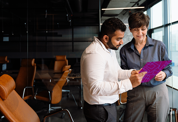 Professionals discussing ideas during a meeting in a modern office.