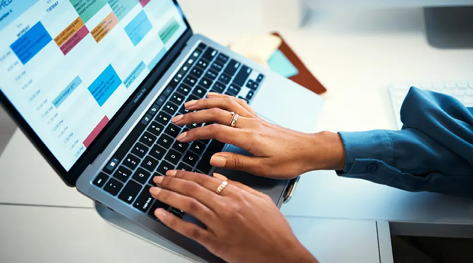 hands typing in a computer