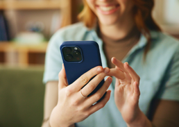 Person using a smartphone and tapping the screen.