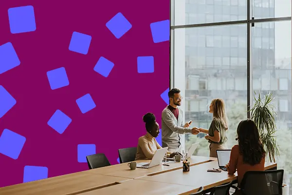 People shaking hands in a meeting room.