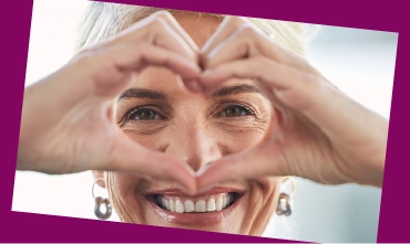 Person making a heart shape with their hands.