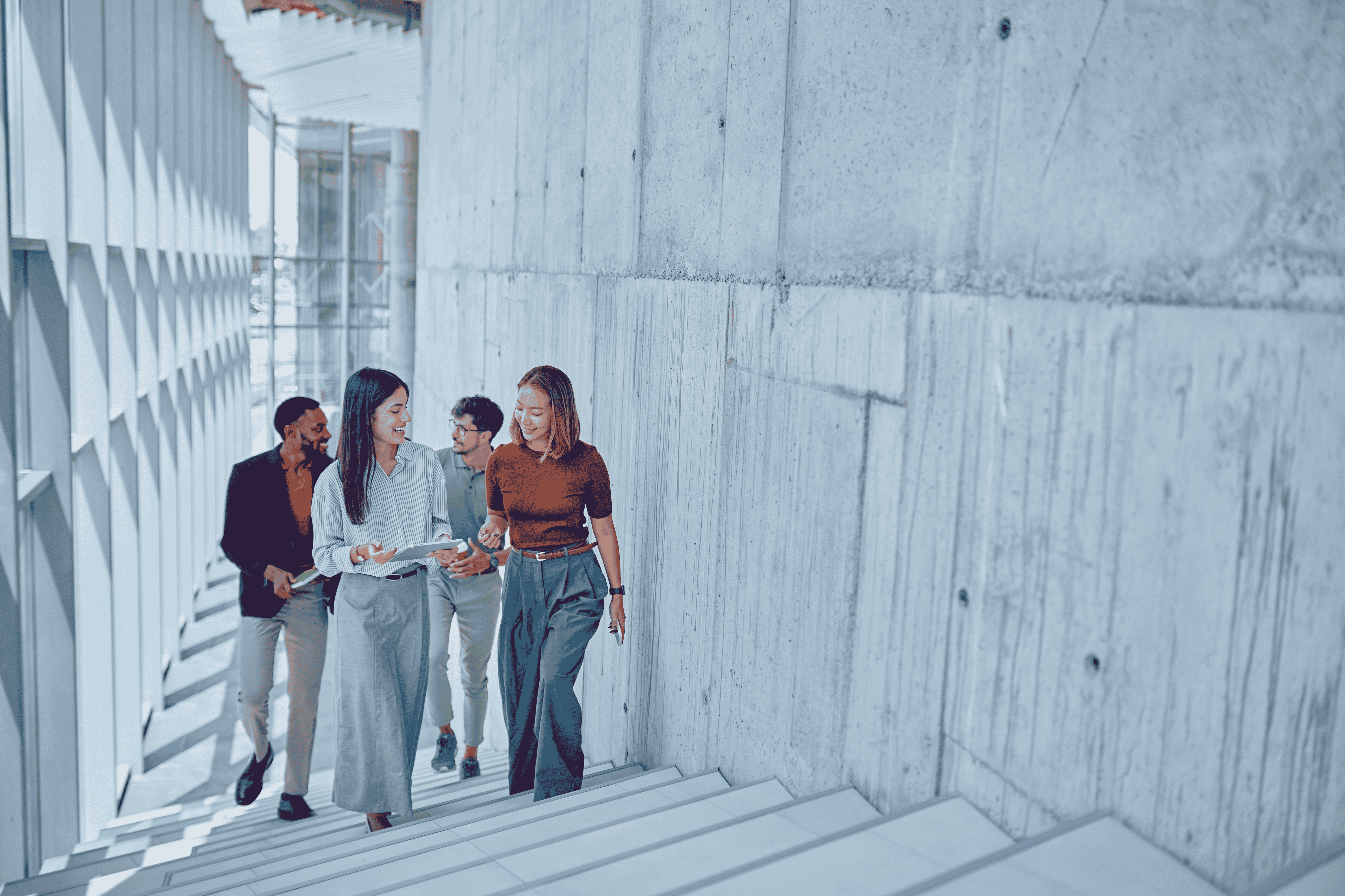 Colleagues walking up stairs while discussing work.