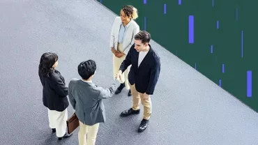 Overhead view of professionals shaking hands in a modern office setting