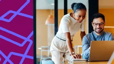 Two people reviewing information together on a laptop.