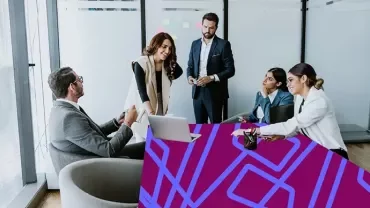 Professionals collaborating during a meeting in a modern office.