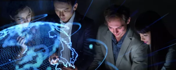 Group of people in business attire with a glowing digital world map overlay.