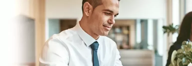 Professional working at a desk in a modern office environment.