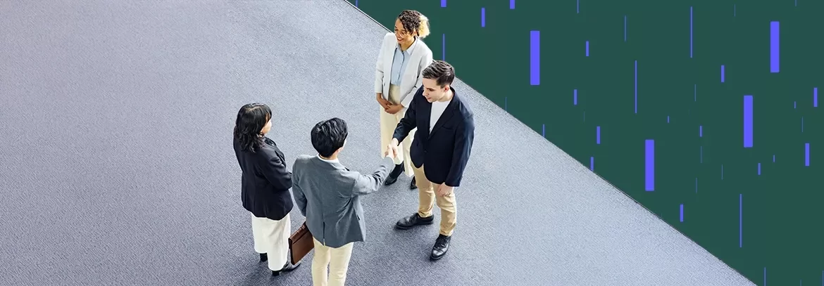 Overhead view of professionals shaking hands in a modern office setting
