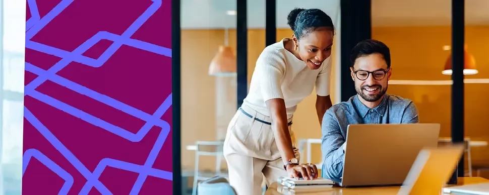 Two people reviewing information together on a laptop.
