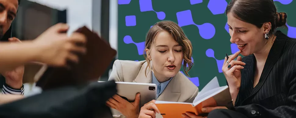 Professionals reviewing notes and a tablet during a collaborative meeting.